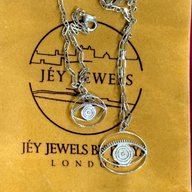 Evil Eye Dangling Bracelet Medium - Silver – handcrafted silver charm bracelet by Jey Jewels by Divya shown with Necklace of same size on sand colour packaging