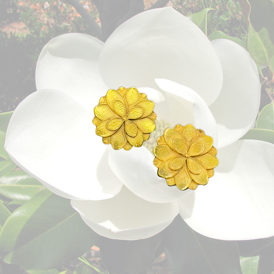 Gold-plated magnolia flower stud earrings with intricate petal detailing, handcrafted by Jéy Jewels by Divya for a timeless, nature-inspired look. on magnolia background