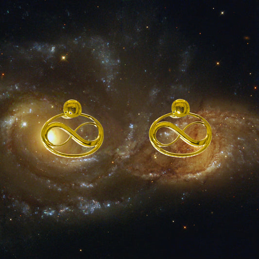 Cosmic Infinity Charm + Studs Earrings Small - Gold – symbolic stud or hoop earrings designed by Jéy Jewels by Divya on cosmic galaxy background