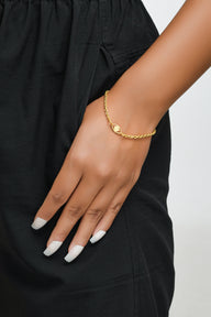 Evil Eye Sitting Charm Bracelet Extra Small - Gold – handcrafted gold or silver charm bracelet by Jey Jewels by Divya on a model hand