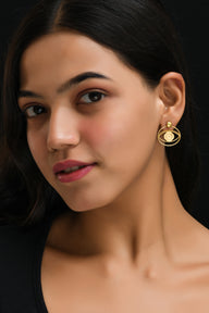 Evil Eye Stud + Hoop Earrings Medium - Gold – symbolic stud or hoop earrings designed by Jey Jewels by Divya on model ear with model face, zoomed out earring view