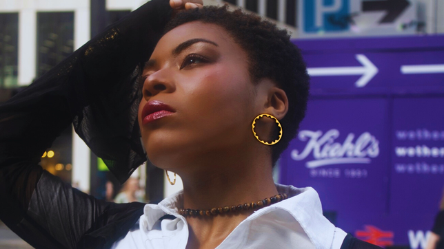 Model wearing earrings - hoops by Jéy Jewels by Divya - Hoop collection - Austrian Alp large hoops. posing in oudoors