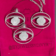Evil Eye Pendant Necklace Large - Silver – elegant pendant necklace with spiritual meaning by Jey Jewels by Divya
Shown with a pair of large earrings on packaging pink background