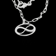 Cosmic Infinity Charm Pendant Necklace Small - Silver – elegant pendant necklace with spiritual meaning by Jéy Jewels by Divya on bkack background zoomed in shot