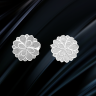 Elegant handcrafted silver magnolia floral stud earrings with a matte finish, designed by Jéy Jewels by Divya, inspired by nature’s delicate beauty.