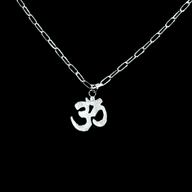 Silver necklace with an Om symbol pendant on a black background by Jéy Jewels by Divya