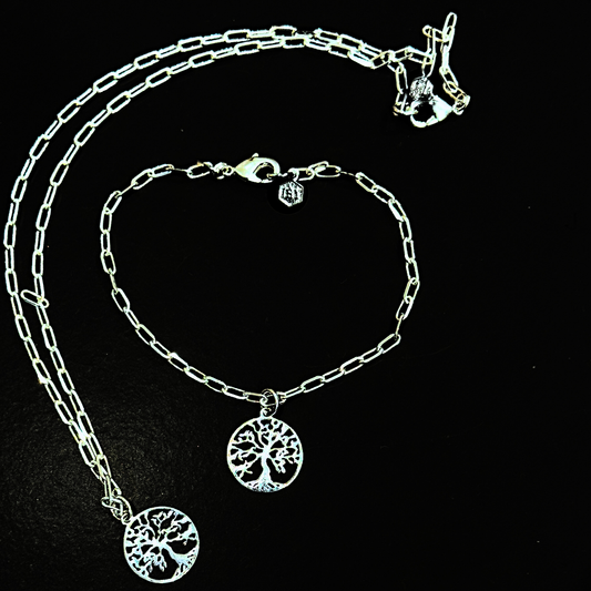 Silver chain bracelet with tree of life charm on a black background with a necklace variation by Jéy Jewels by Divya